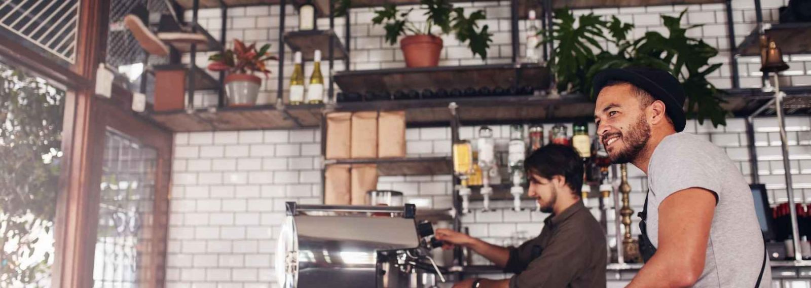 two men working behind the counter at a bar